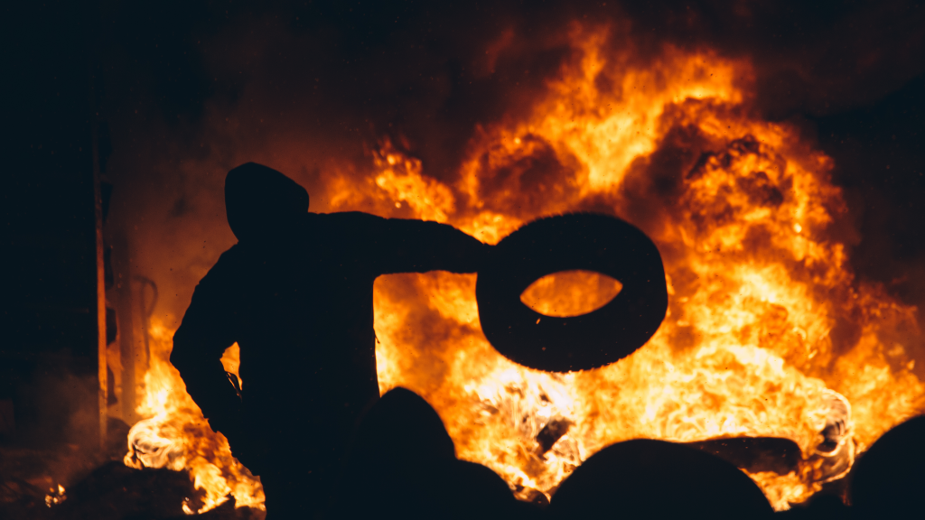 Property protection - arsonist throwing a tire into a burning building