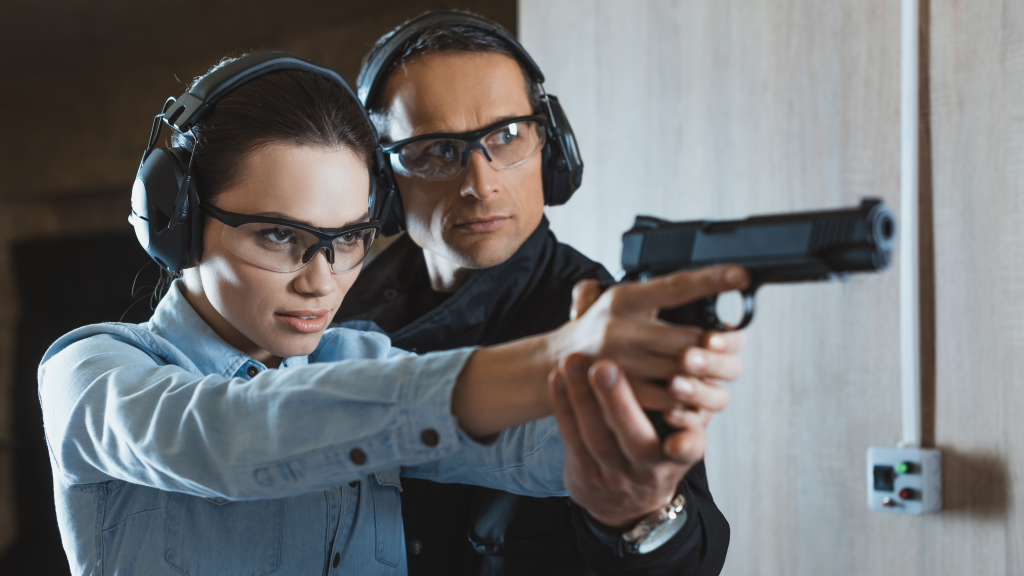 Firearms instructor teaching a woman how to shoot a handgun - Firearms Traning - Lycan Security