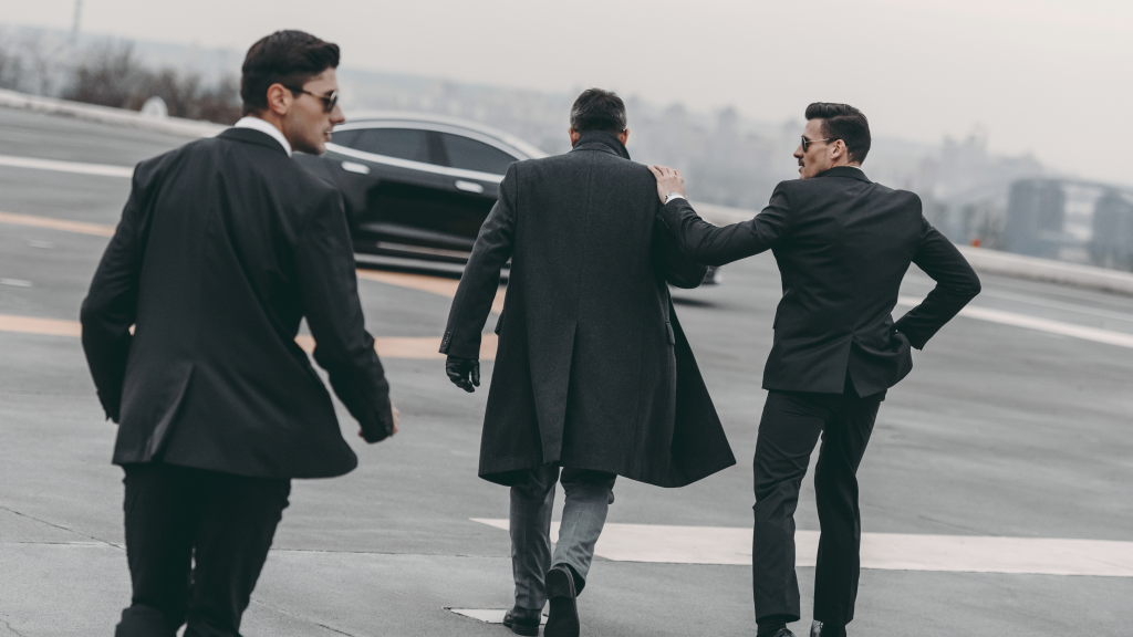 Two bodyguards escort a V.I.P. to his car - Executive Protection - Personal Protection - Lycan Security